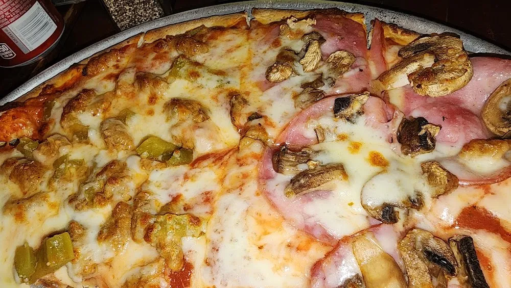 Half Green Chile with Sausage Half Canadian Bacon with Ushroomsm